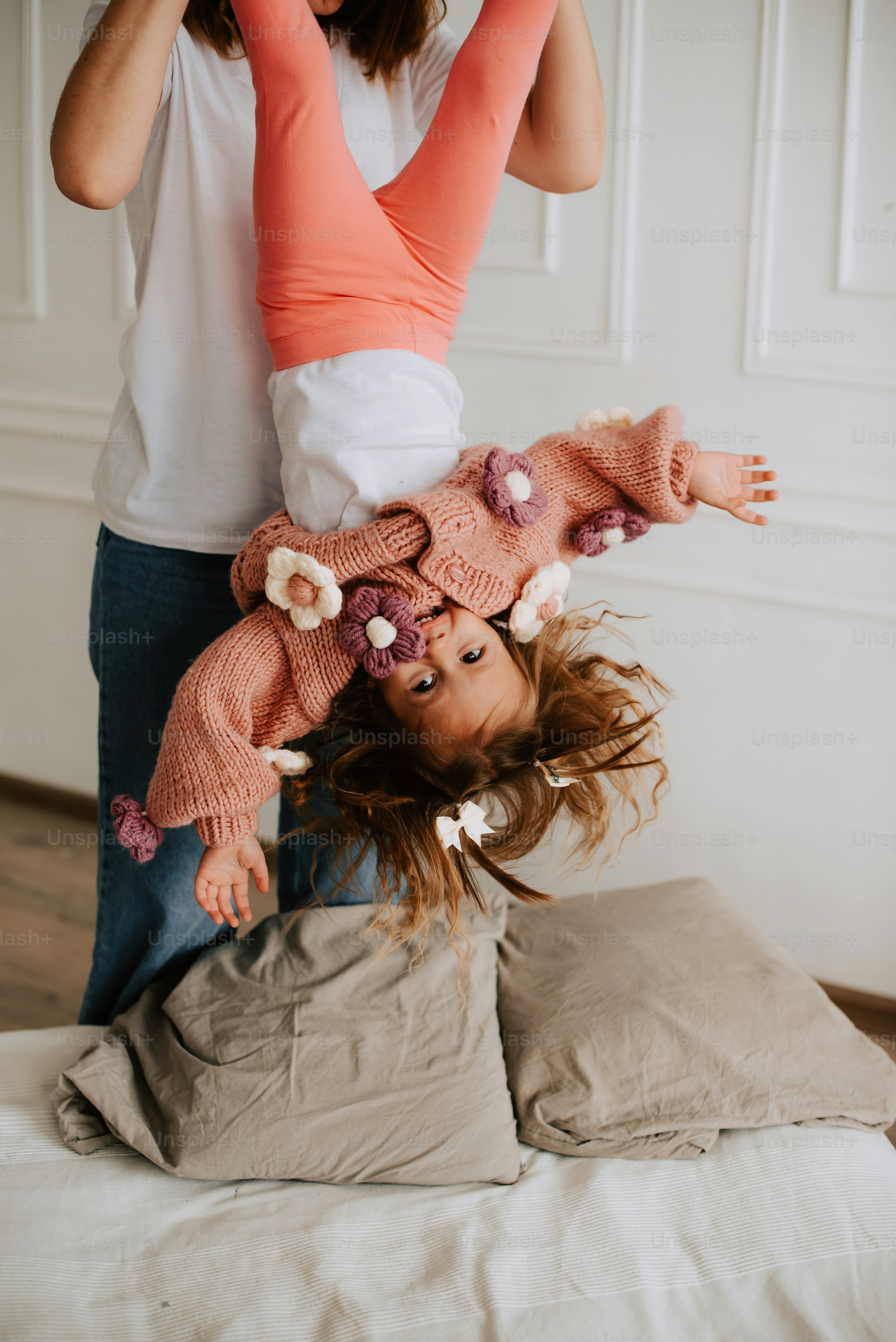 a young girl upside down on a bed
