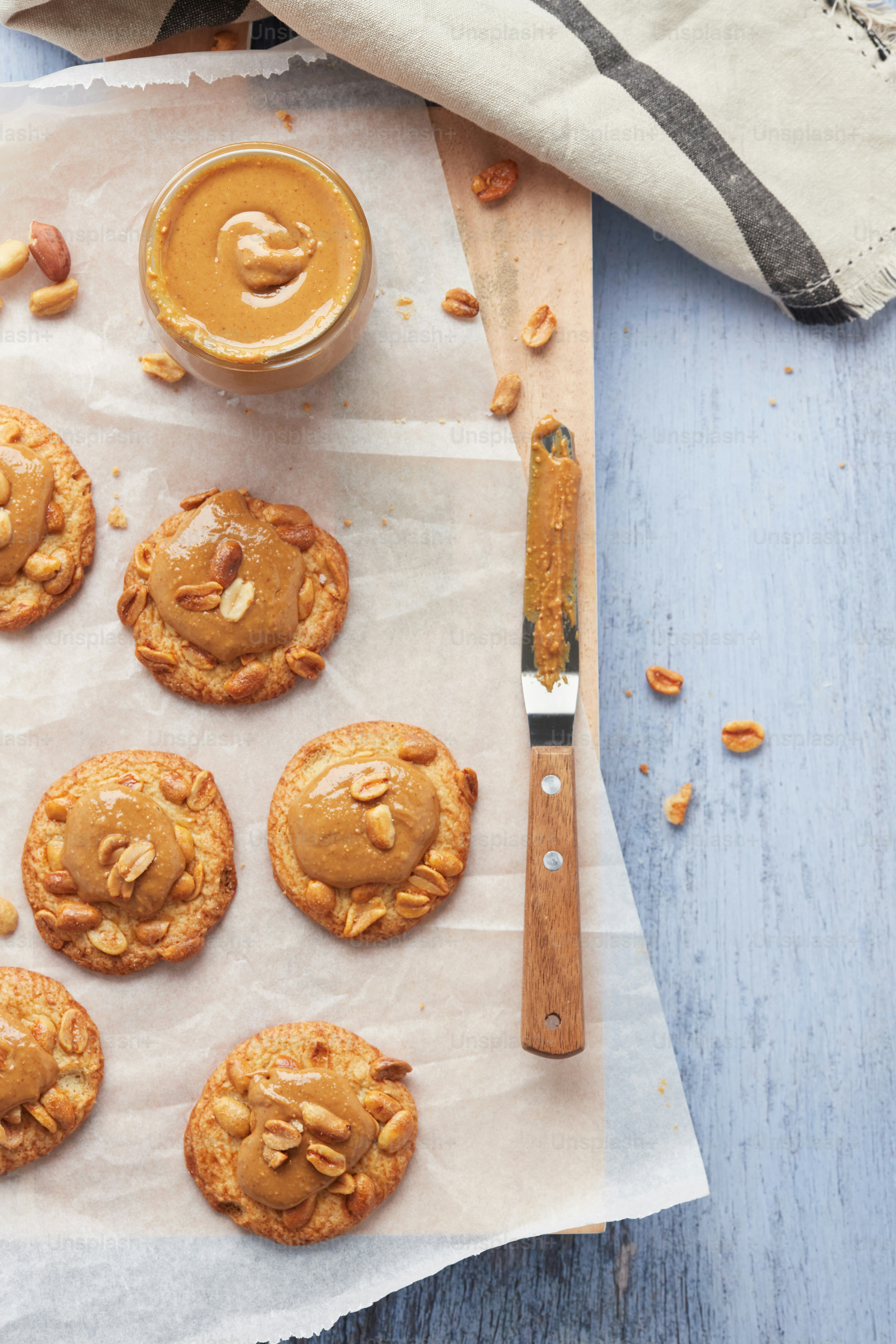 Baking paper with peanut cookies and peanut butter