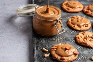 a cookie with peanut butter and a jar of peanut butter