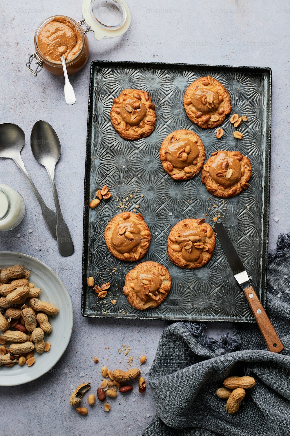 a tray of peanut butter cookies next to a cup of coffee