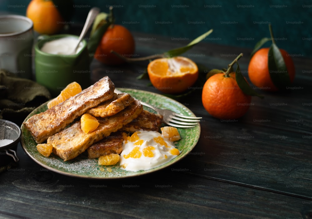 a plate of french toast with oranges and yogurt