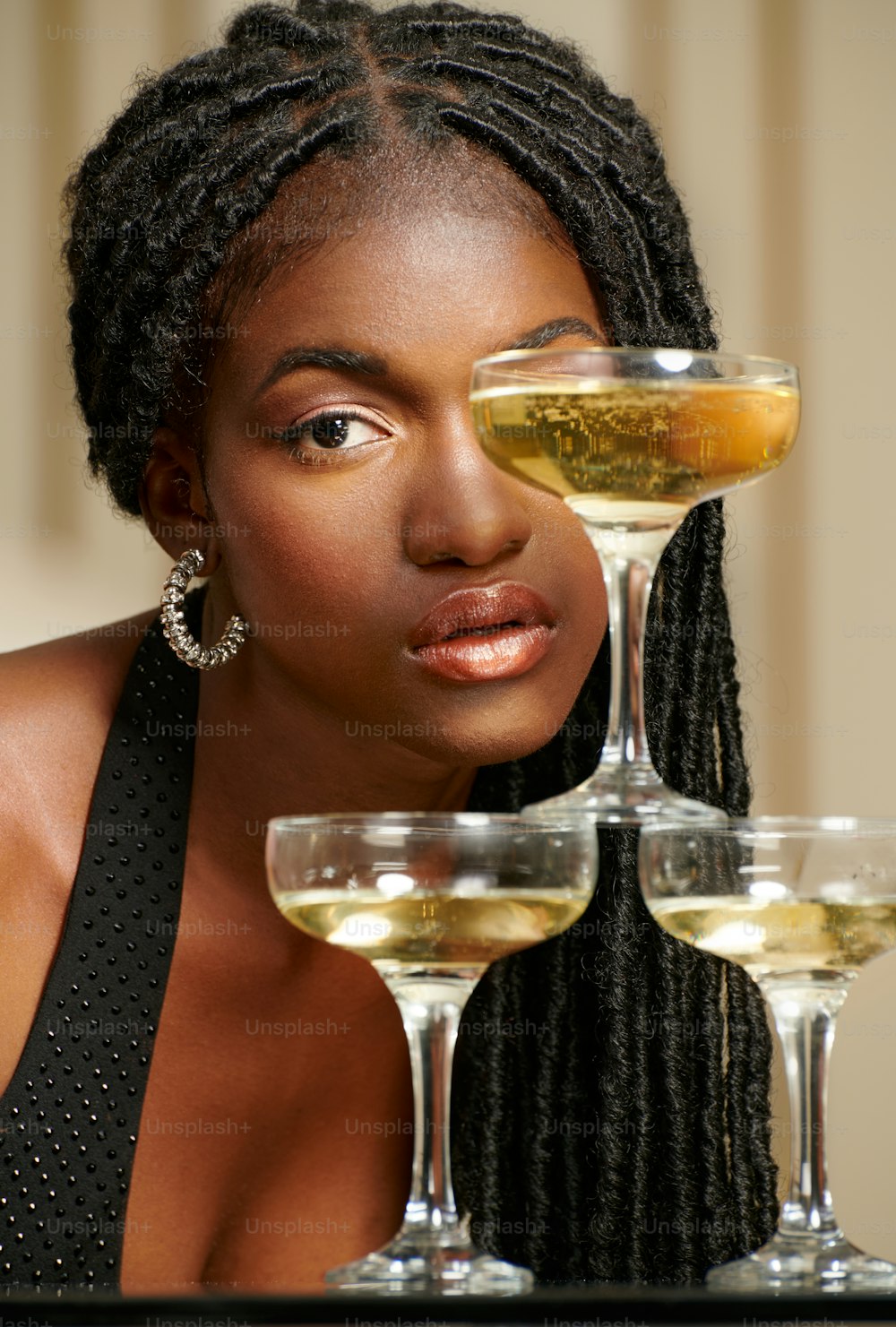 a woman sitting at a table with three glasses of wine