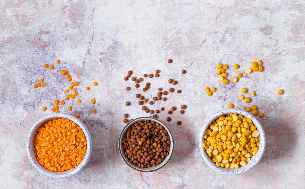 three bowls filled with different types of food