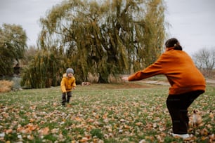 a woman and a child playing with a frisbee