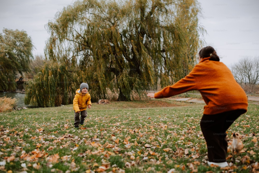 a woman and a child playing with a frisbee