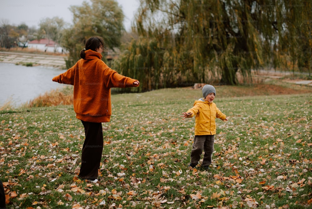 two young children playing with a frisbee in a field