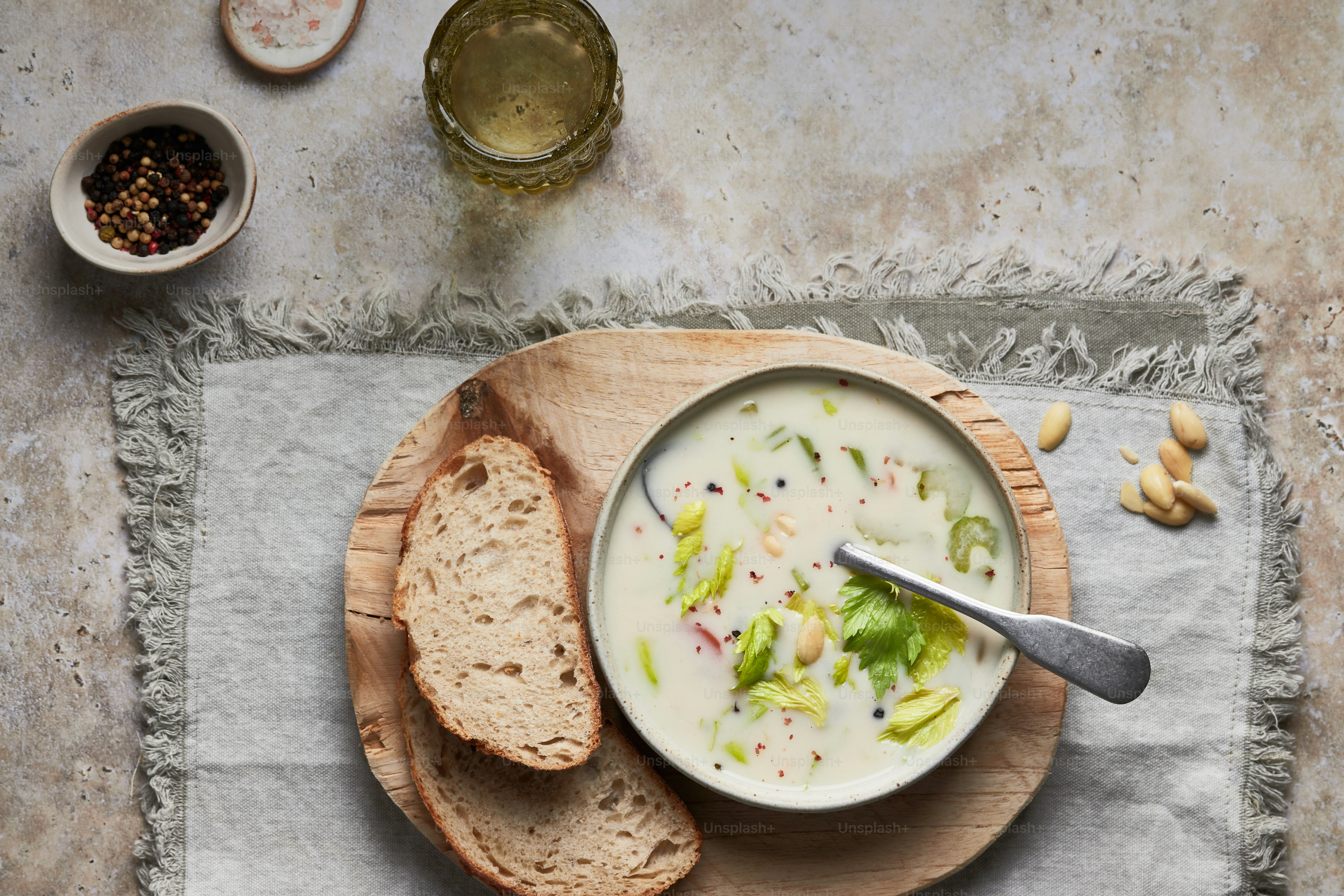 a bowl of soup on a wooden plate