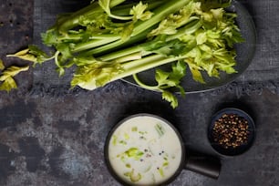 a bowl of broccoli next to a bowl of soup