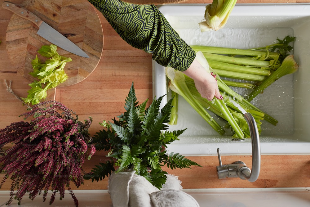 a person cutting celery on a cutting board