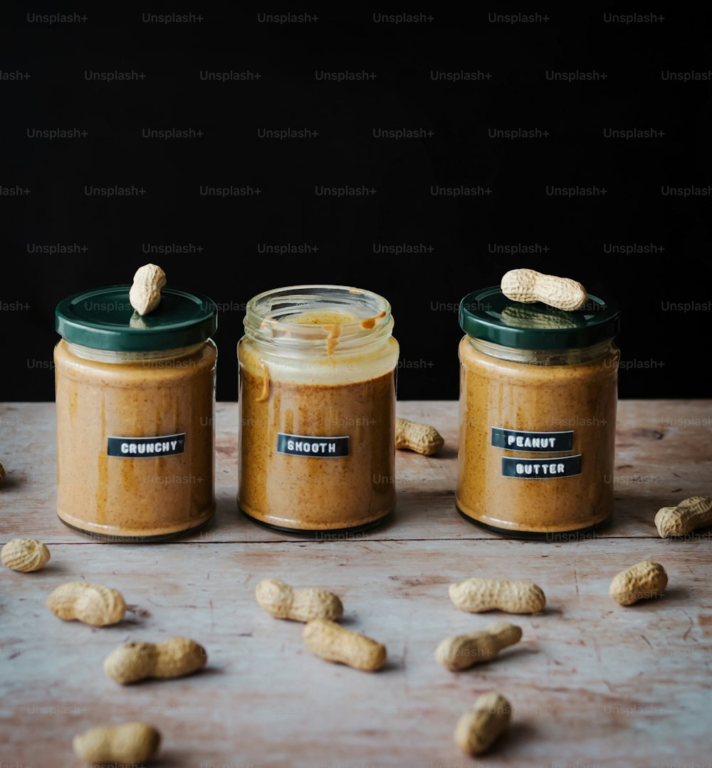 three jars of peanut butter on a table