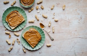 two plates with peanut butter and peanuts on them