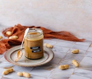 a jar of peanut butter sitting on a plate