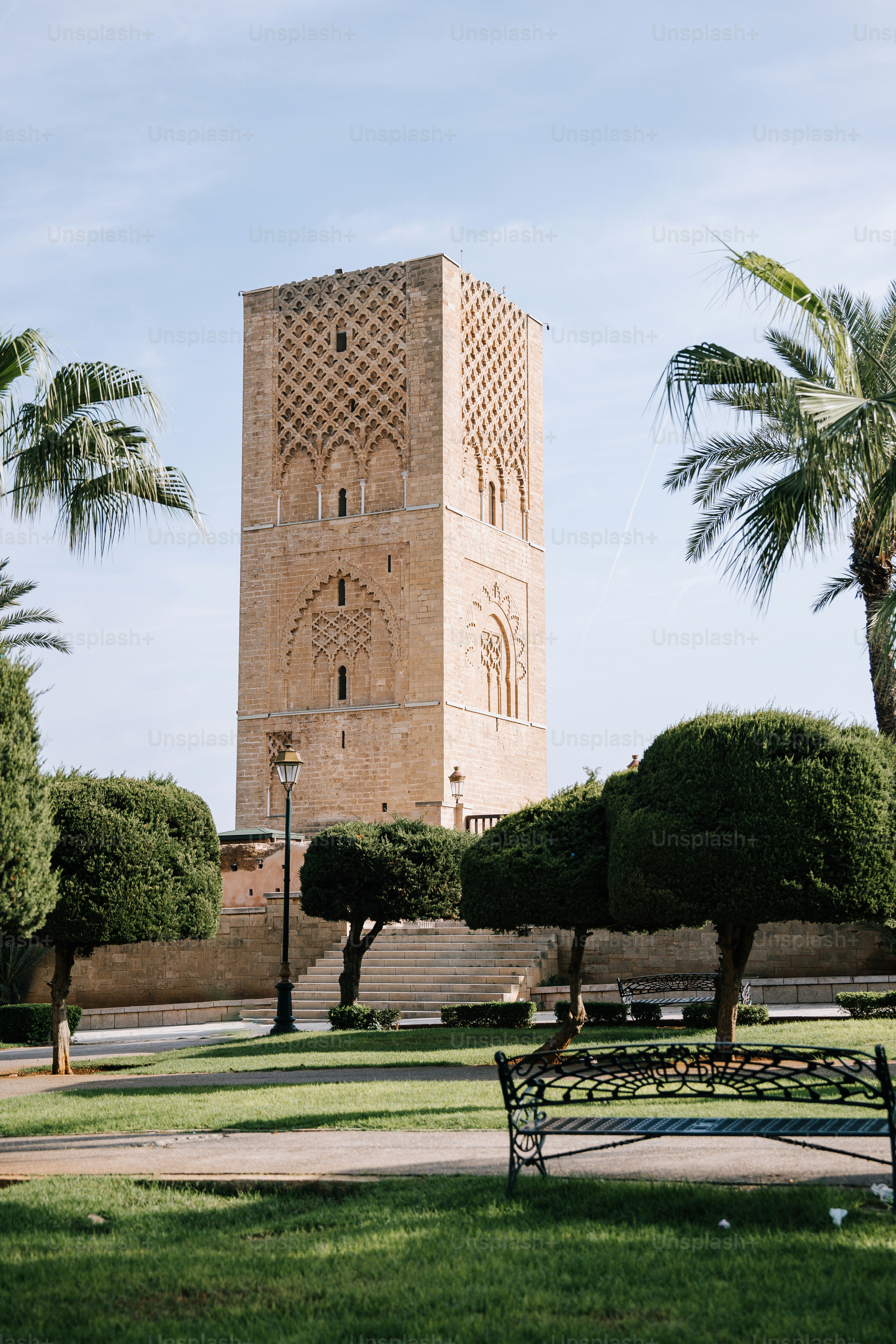 a tall tower sitting next to a lush green park