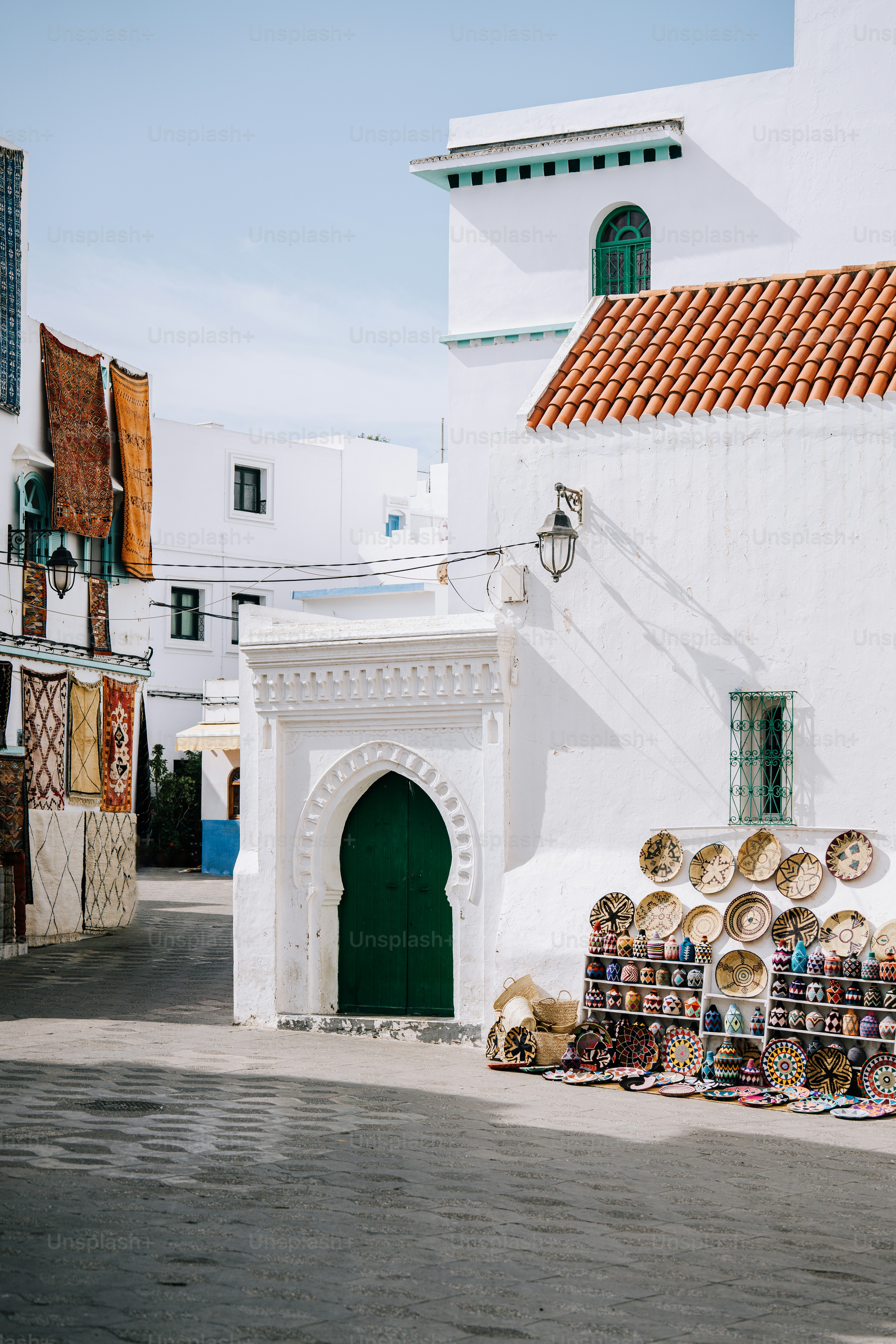 a small white building with a green door