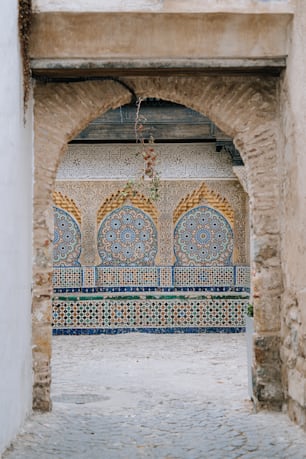 an archway in a building with a decorative tile design
