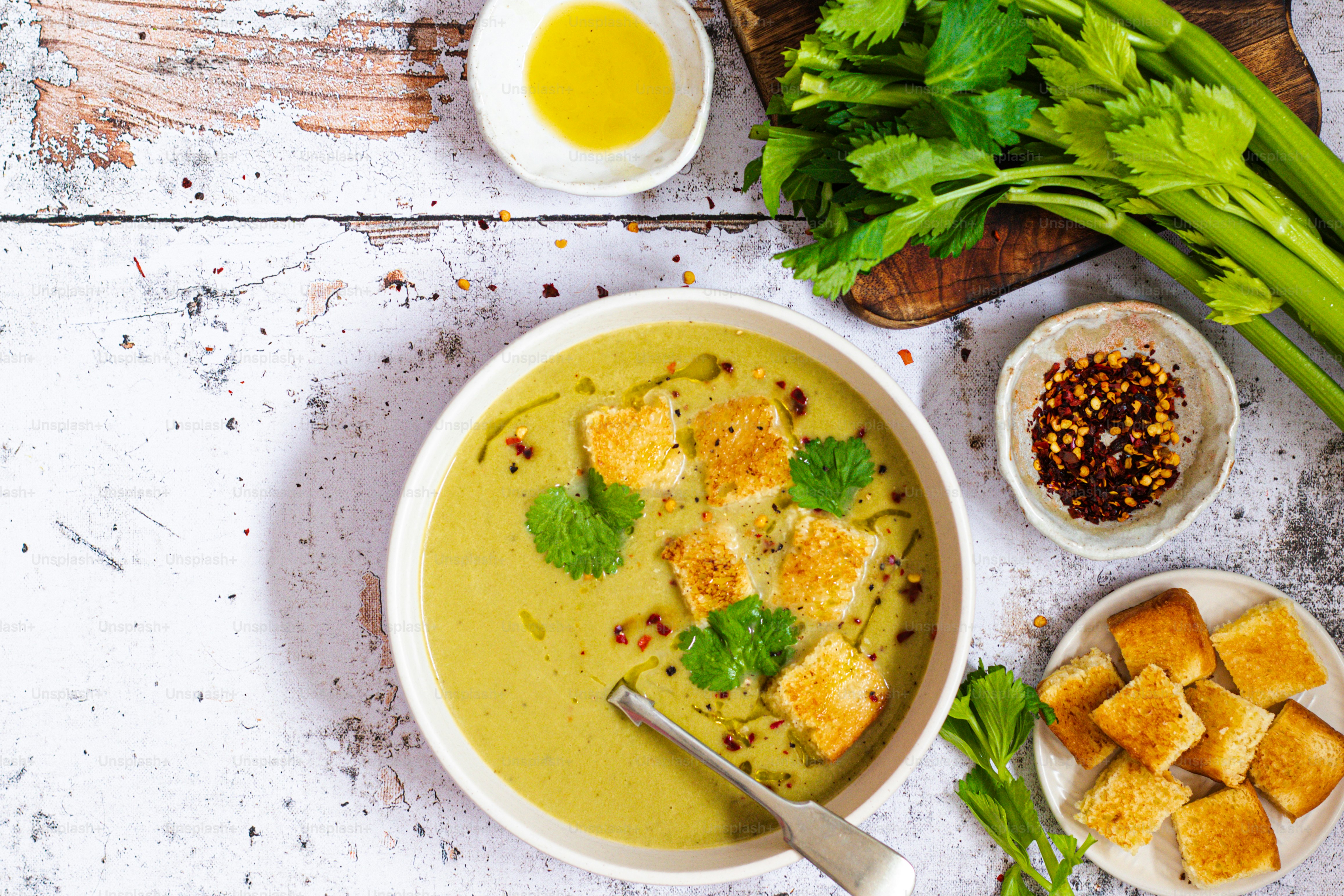 a bowl of soup with tofu and green onions