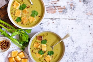 two bowls of soup with tofu and green onions