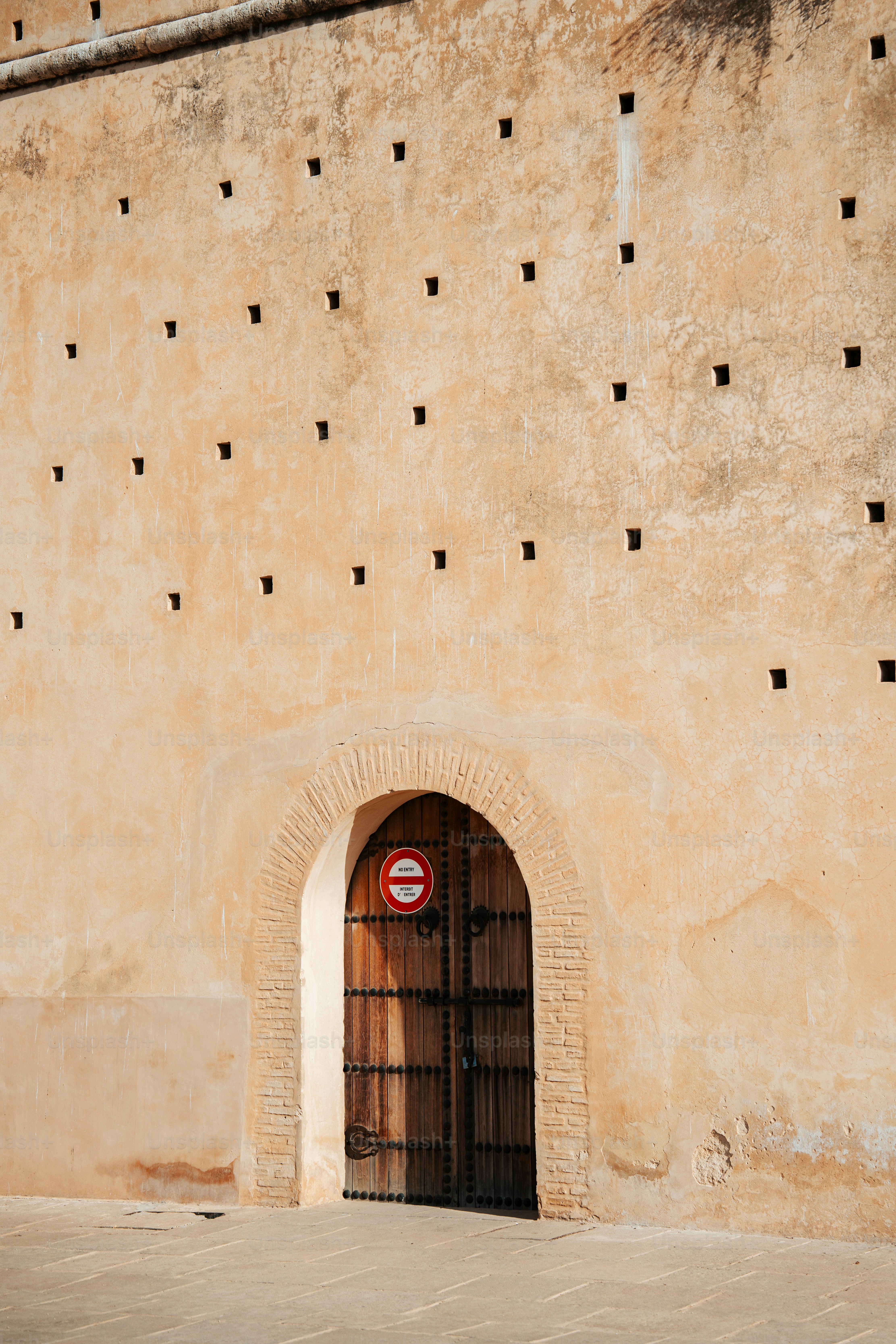 a door with a sign on it in front of a wall