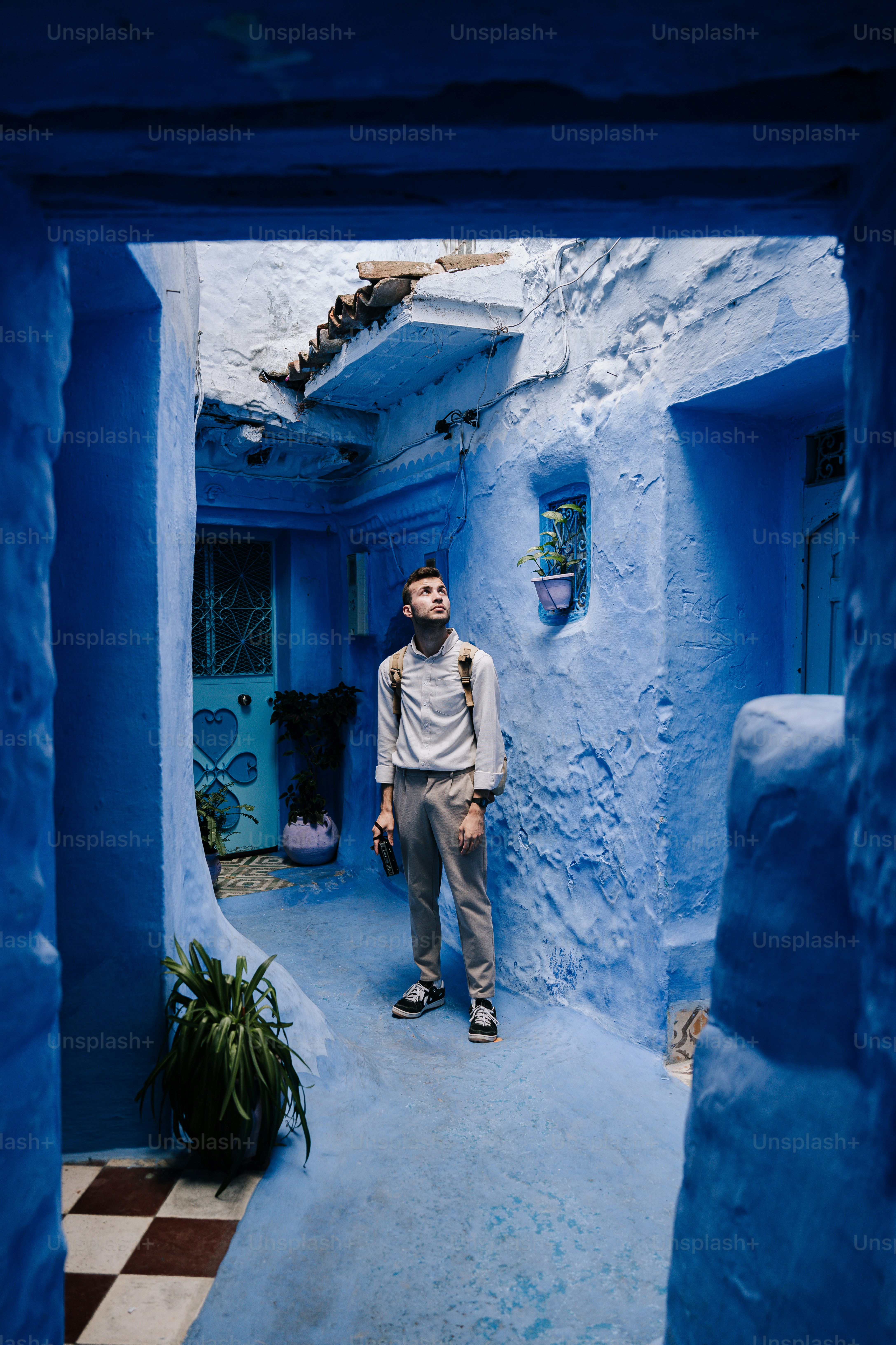 a man standing in a narrow alley way