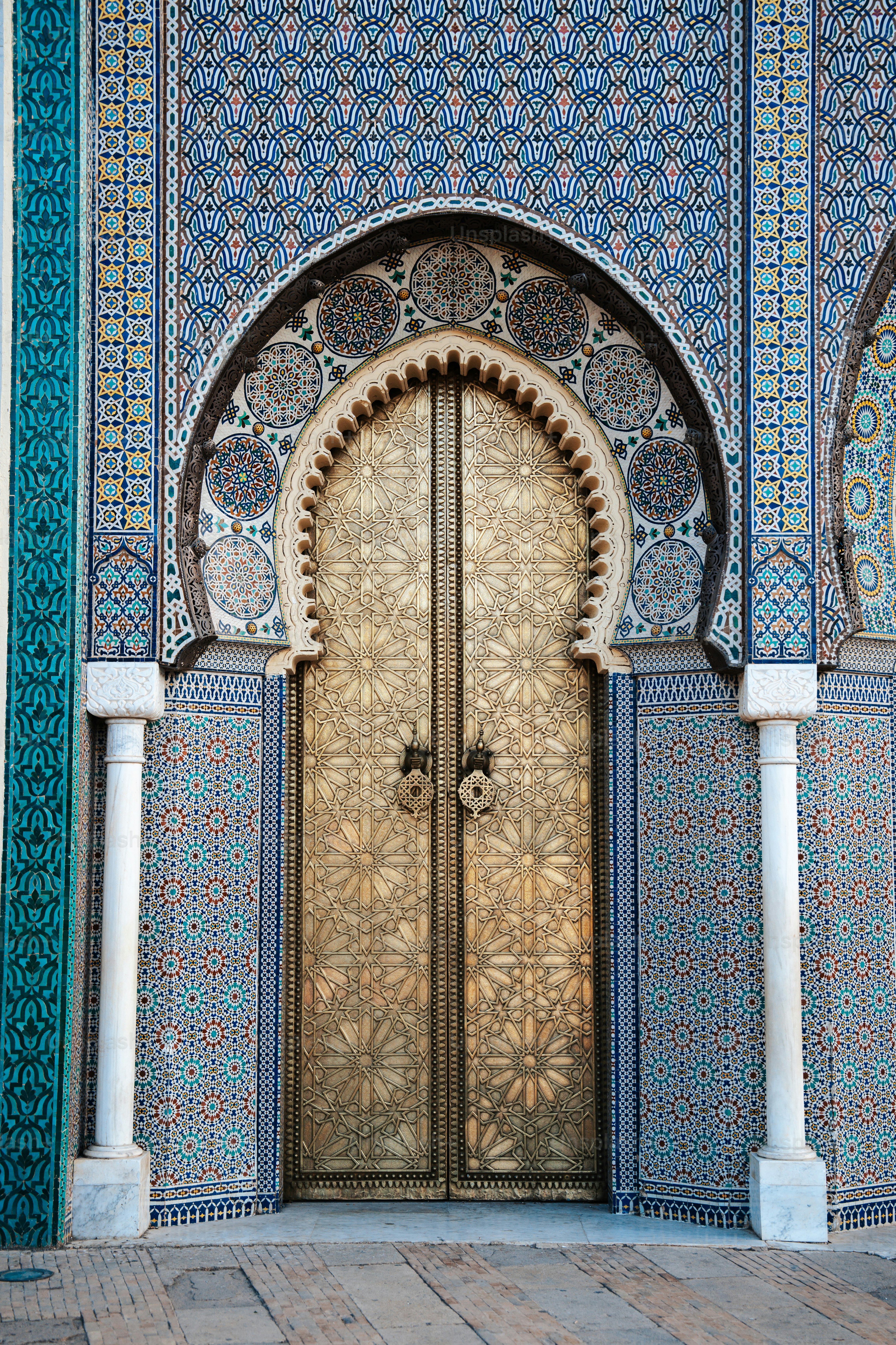 an ornate doorway with a wooden door in the middle