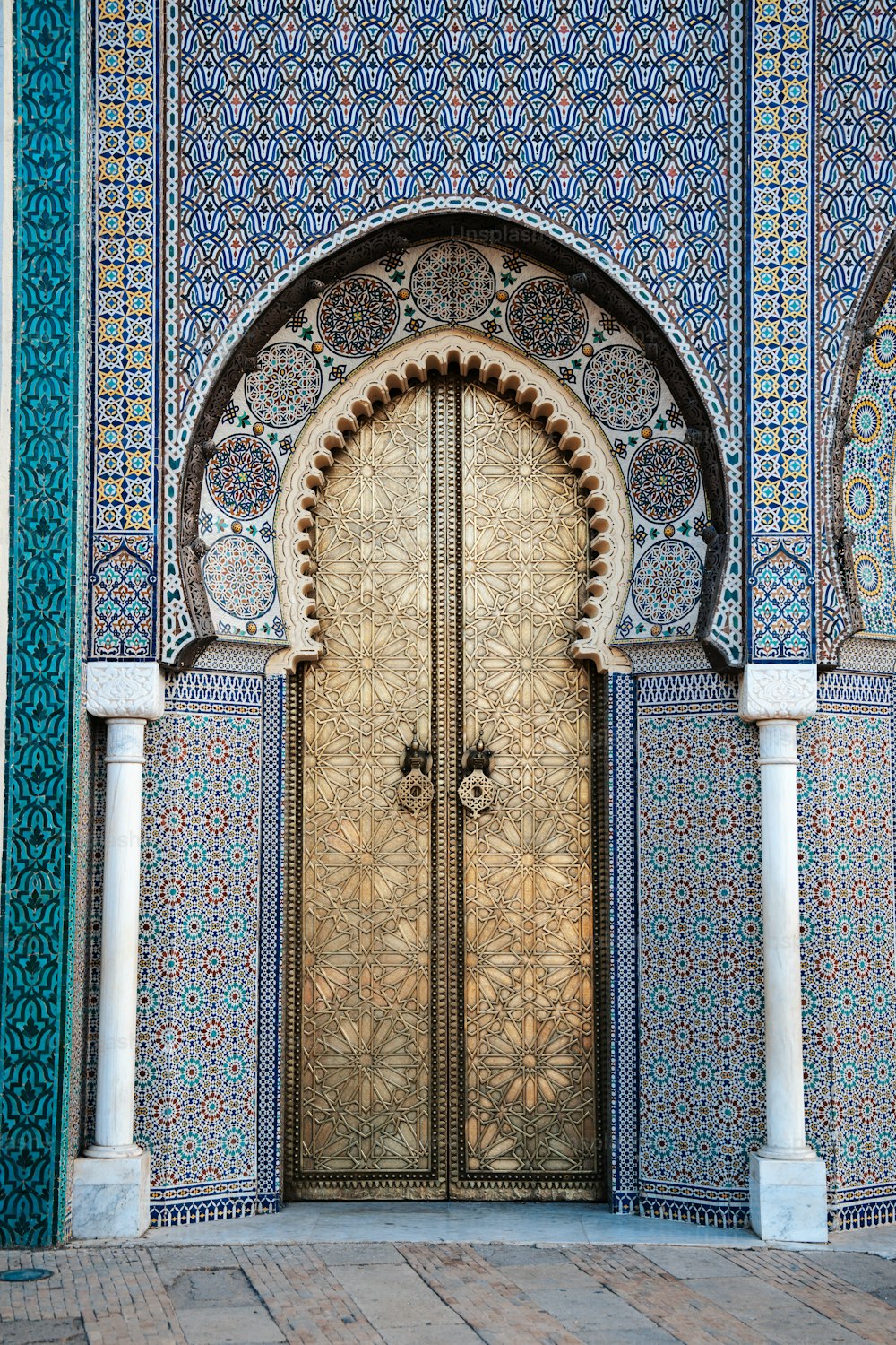 an ornate doorway with a wooden door in the middle