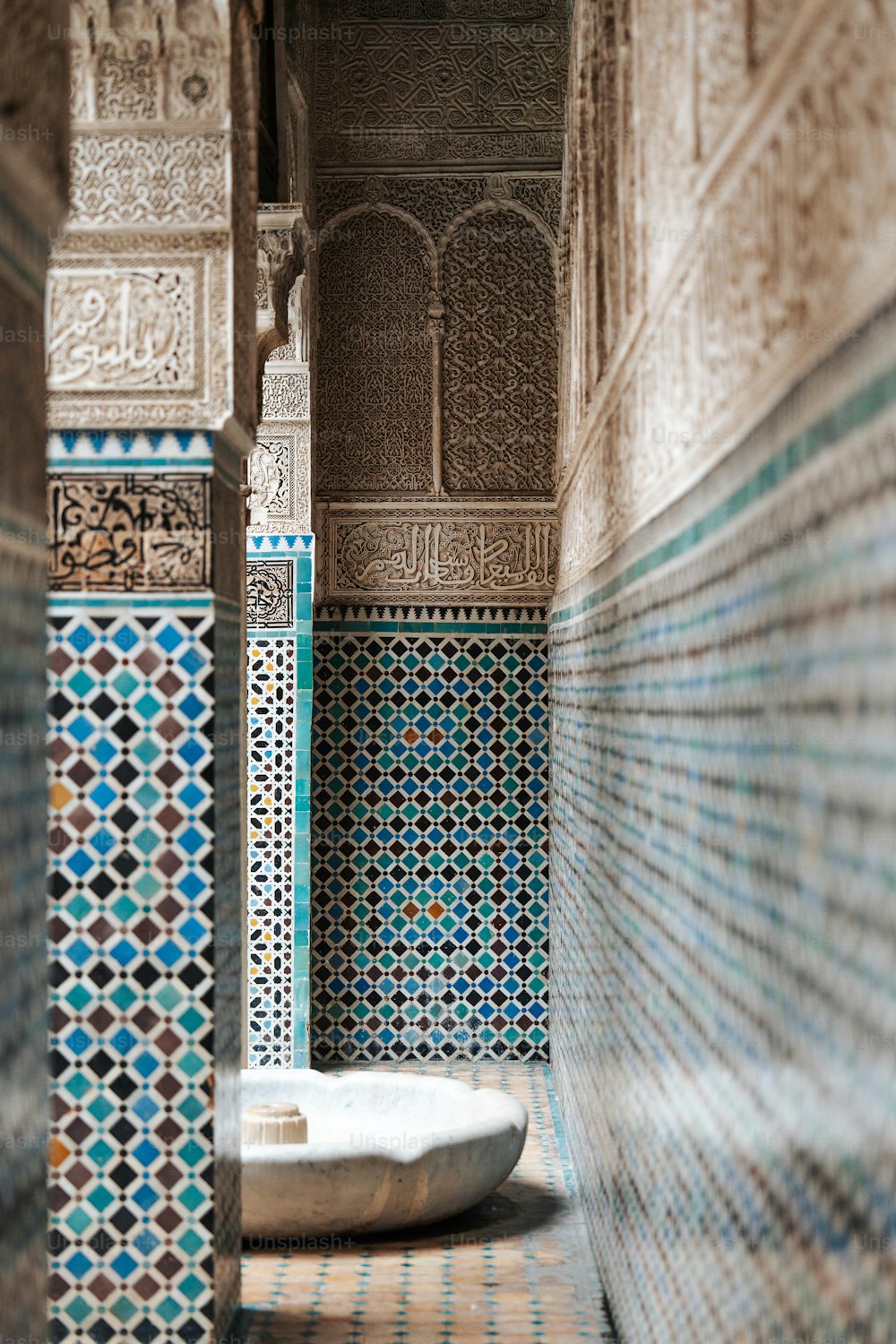 a bathtub in the middle of a tiled room