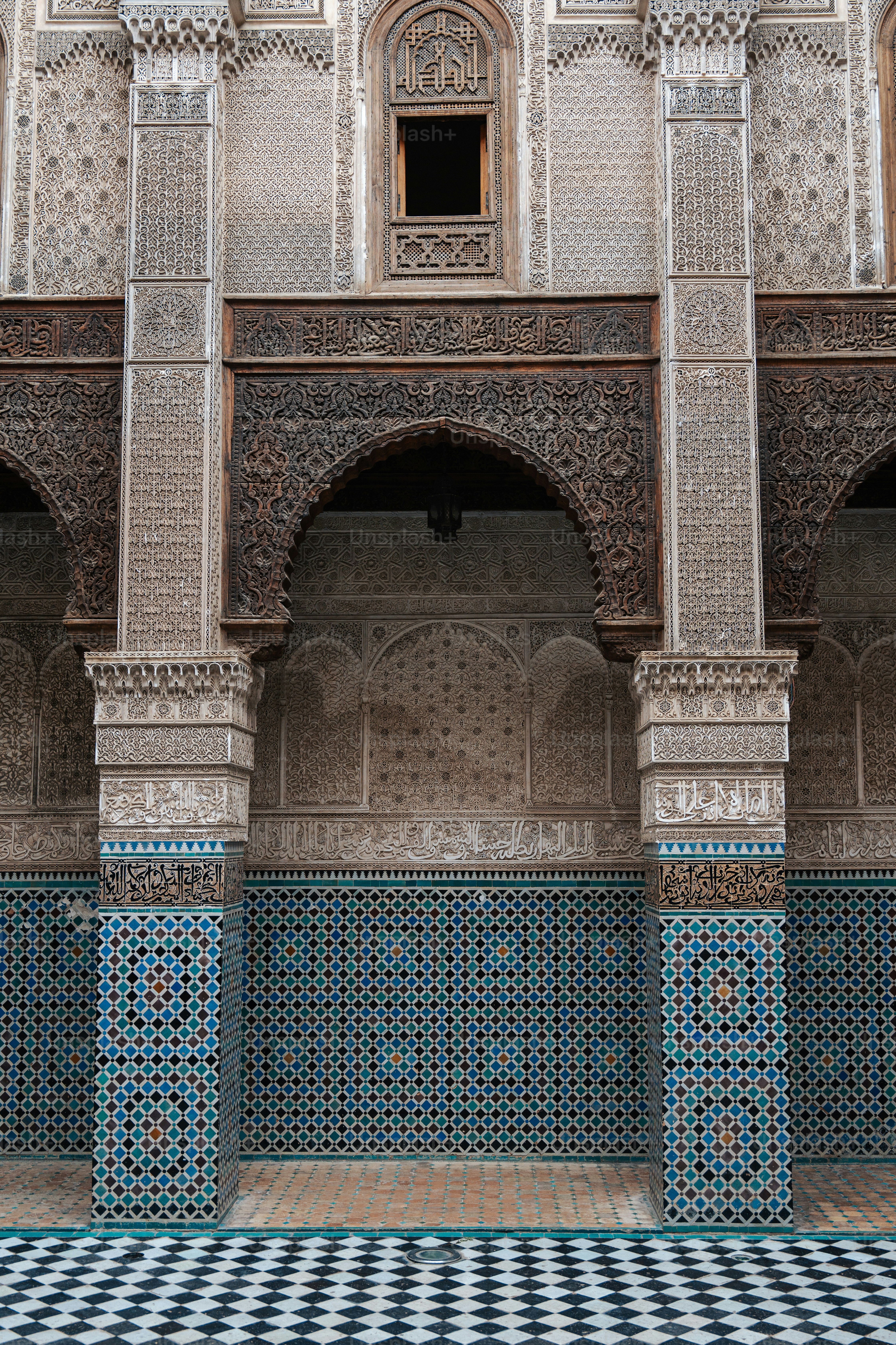 a blue and white tiled wall and floor in a building