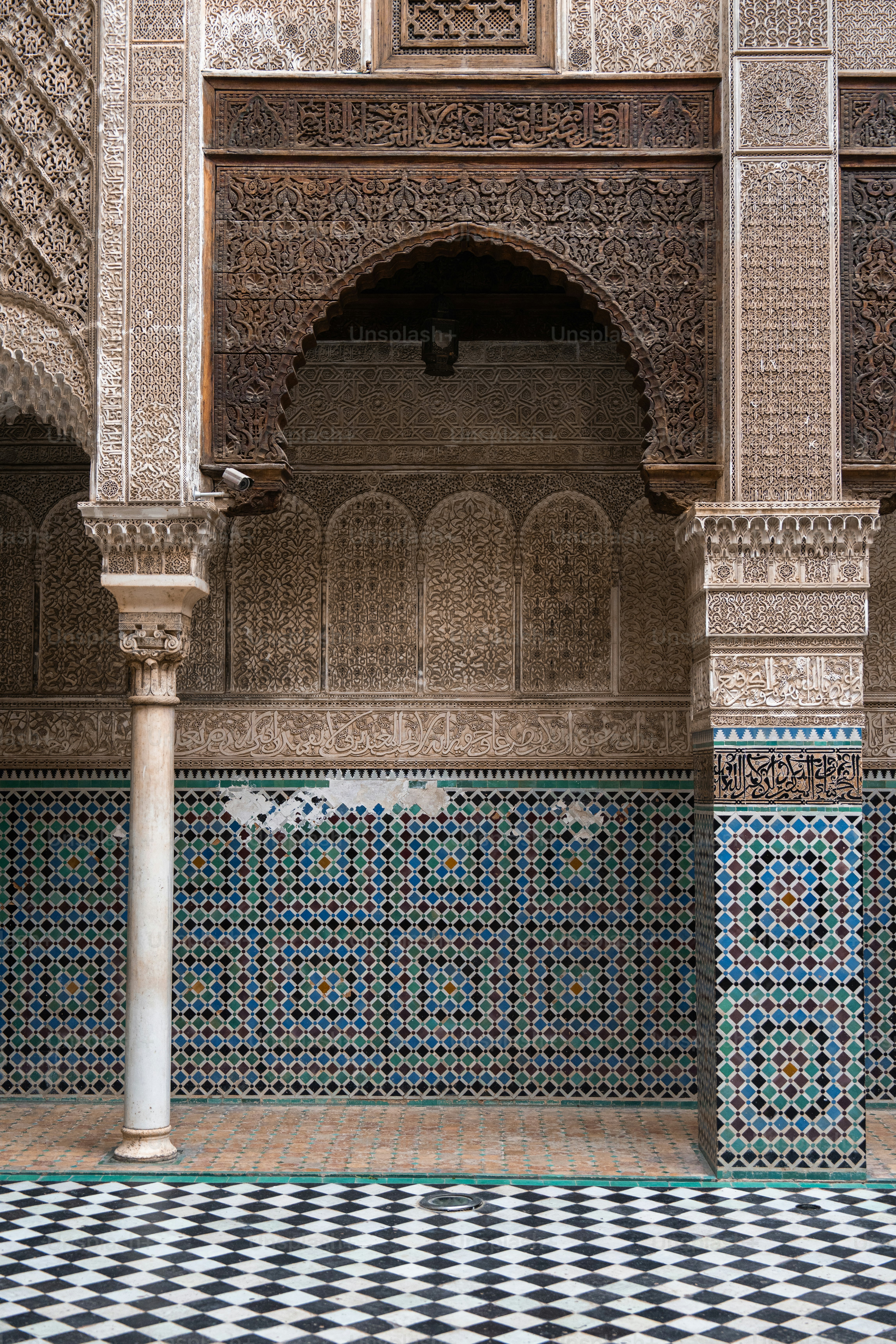 a tiled room with columns and a checkered floor