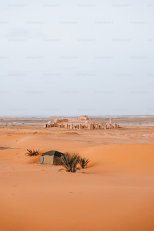 a small hut in the middle of a desert