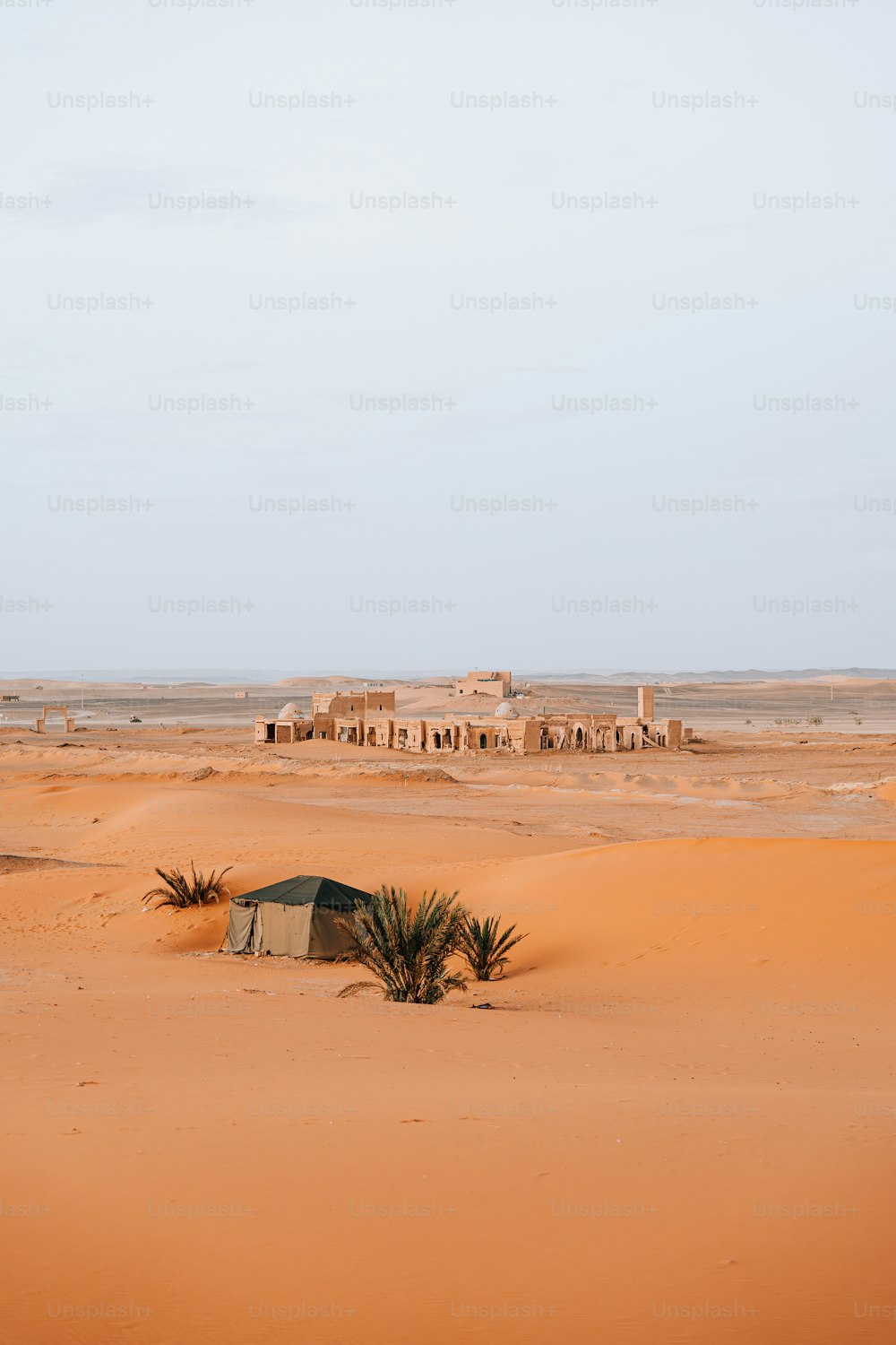 a small hut in the middle of a desert