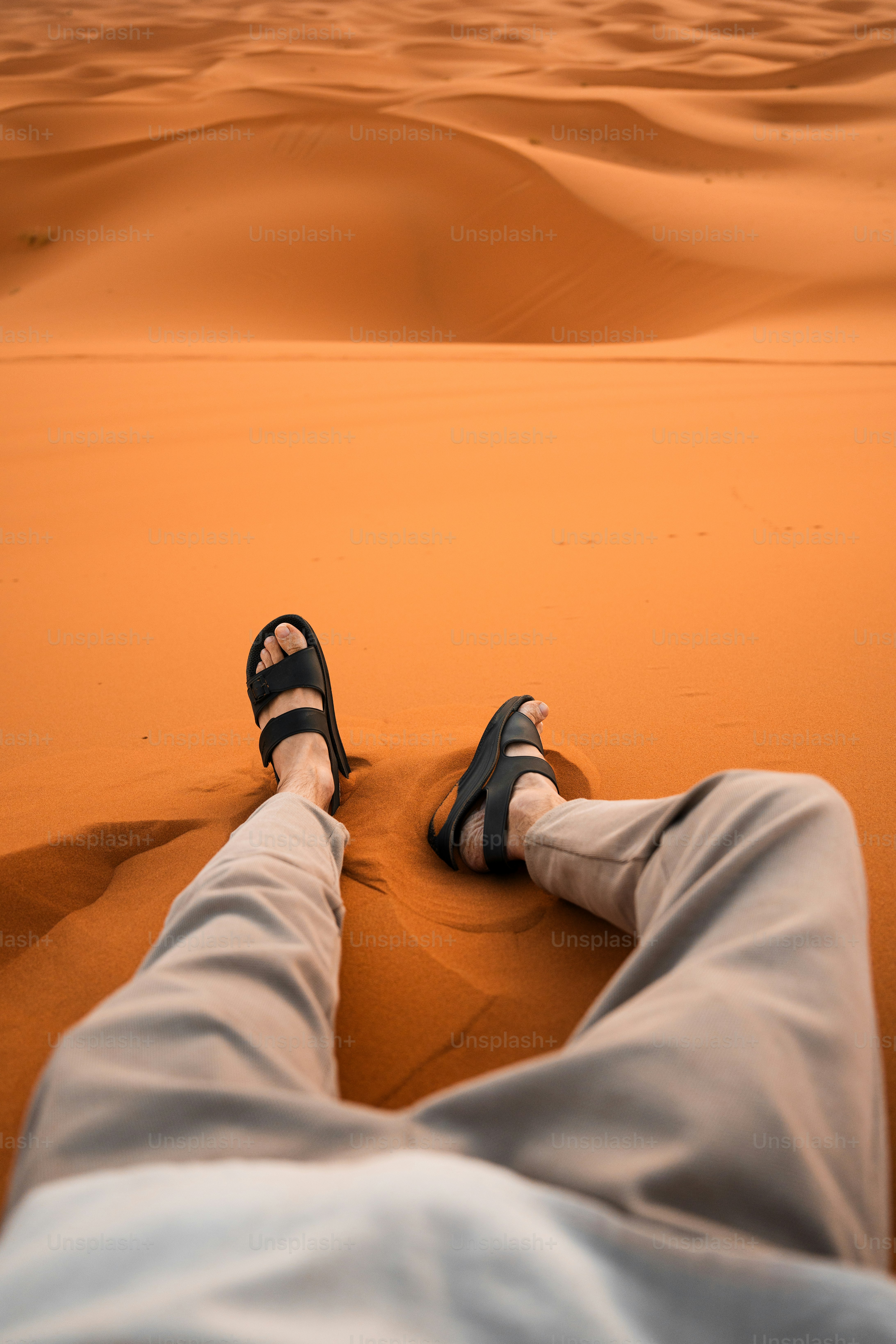 a person laying on top of a sandy beach