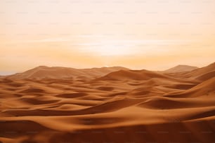 the sun is setting over the sand dunes