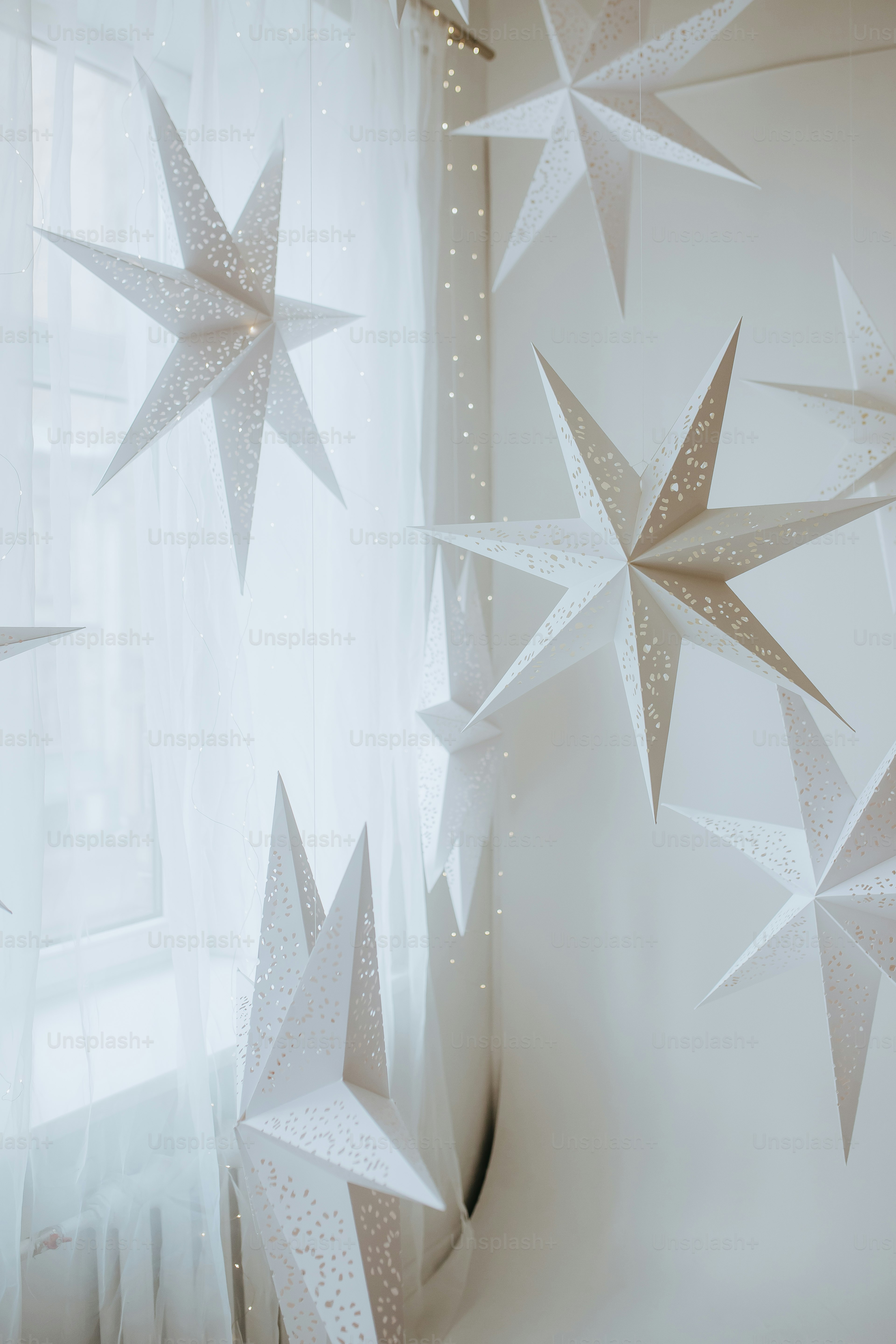 A Window With A Curtain And Some Paper Stars Hanging From It Photo   Premium Photo 1699536521927 Cbf1a932008b