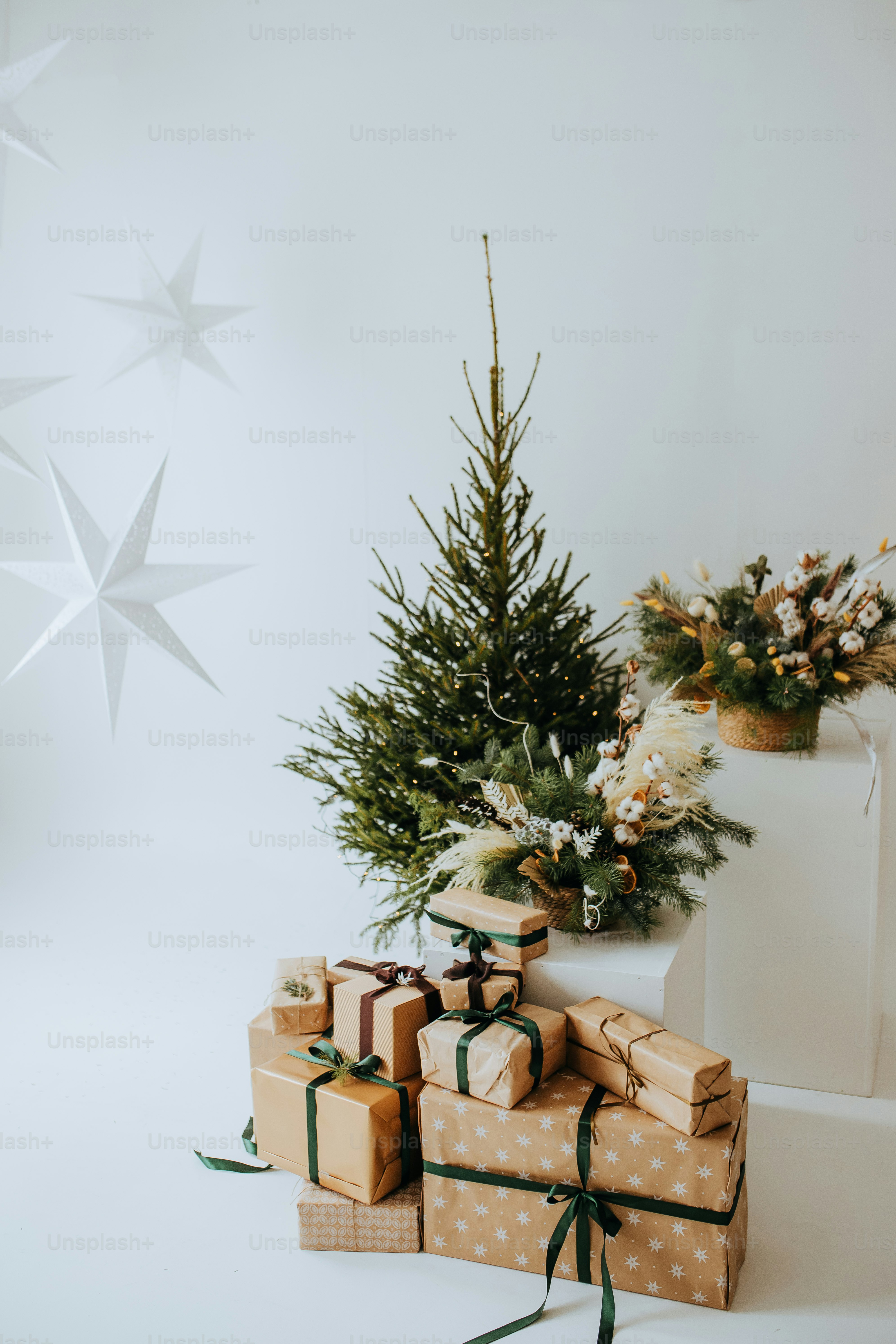 A white christmas tree with presents under it photo – Christmas tree ...