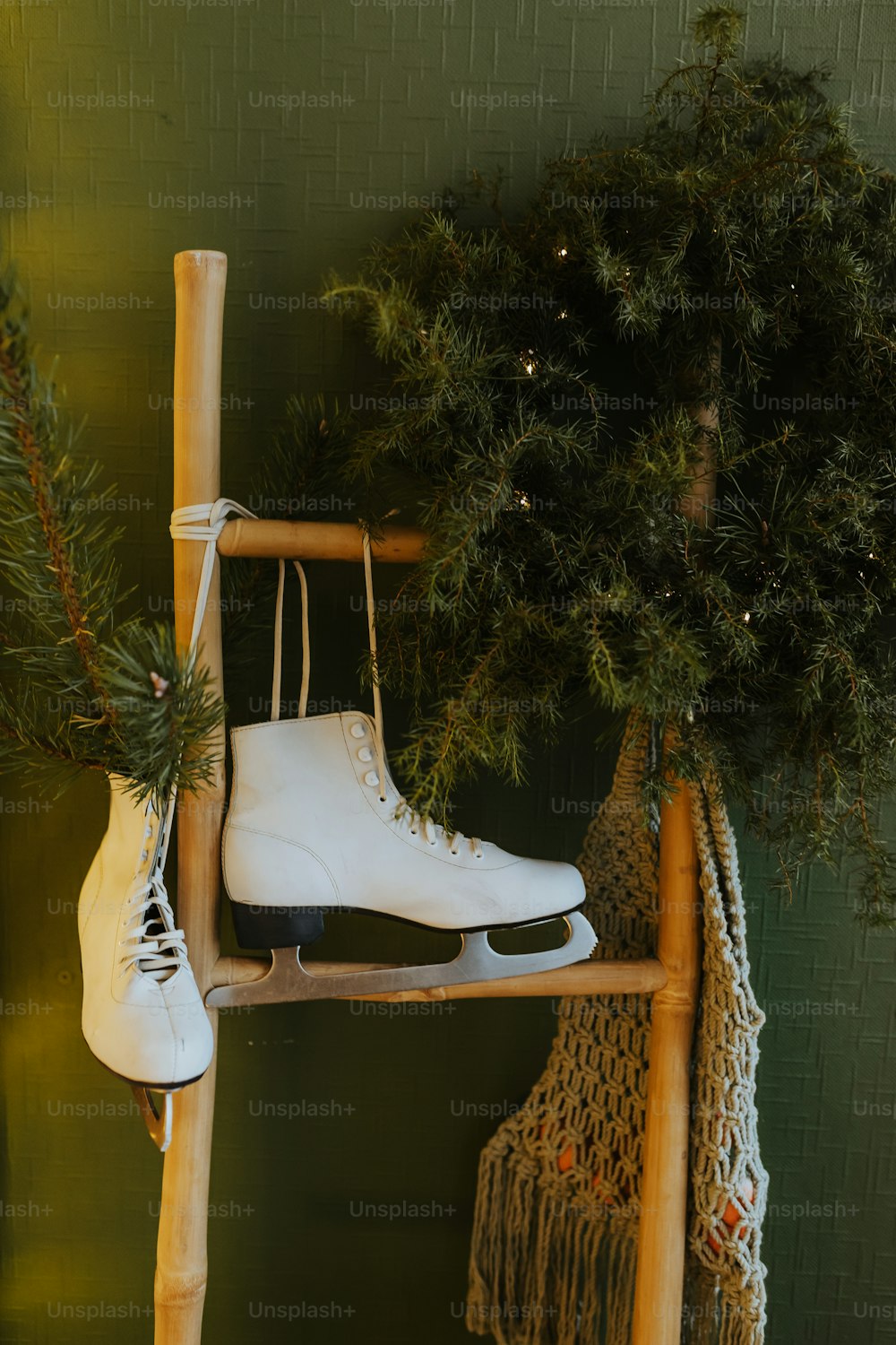 a pair of ice skates hanging from a wooden rack