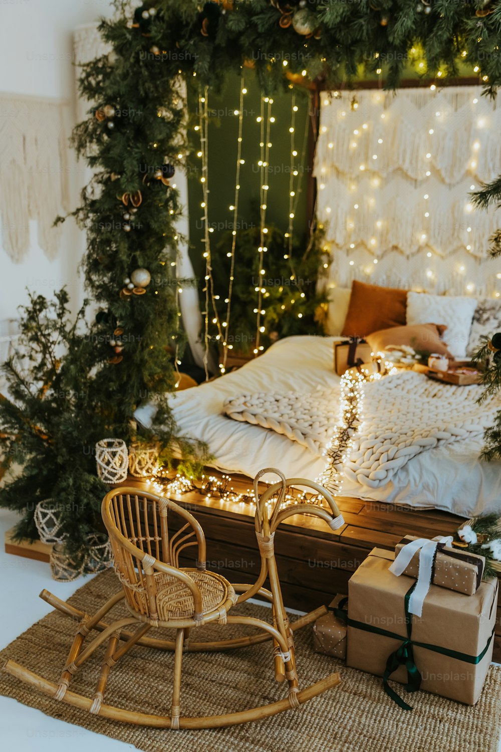 a bedroom decorated for christmas with a sleigh bed