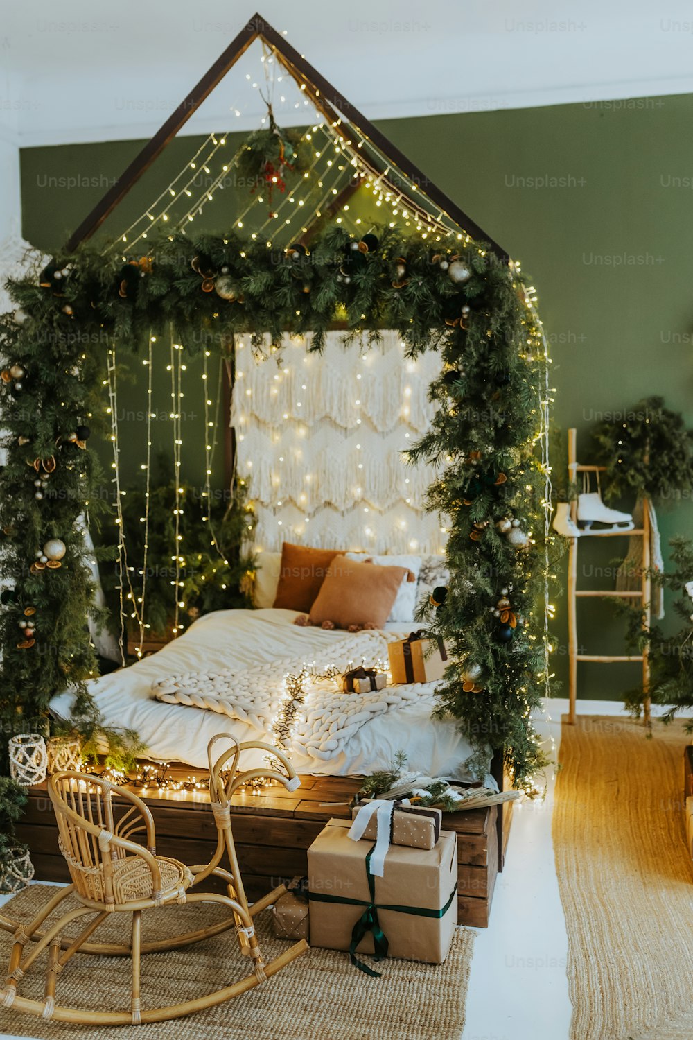 a bedroom decorated for christmas with a bed and a sleigh