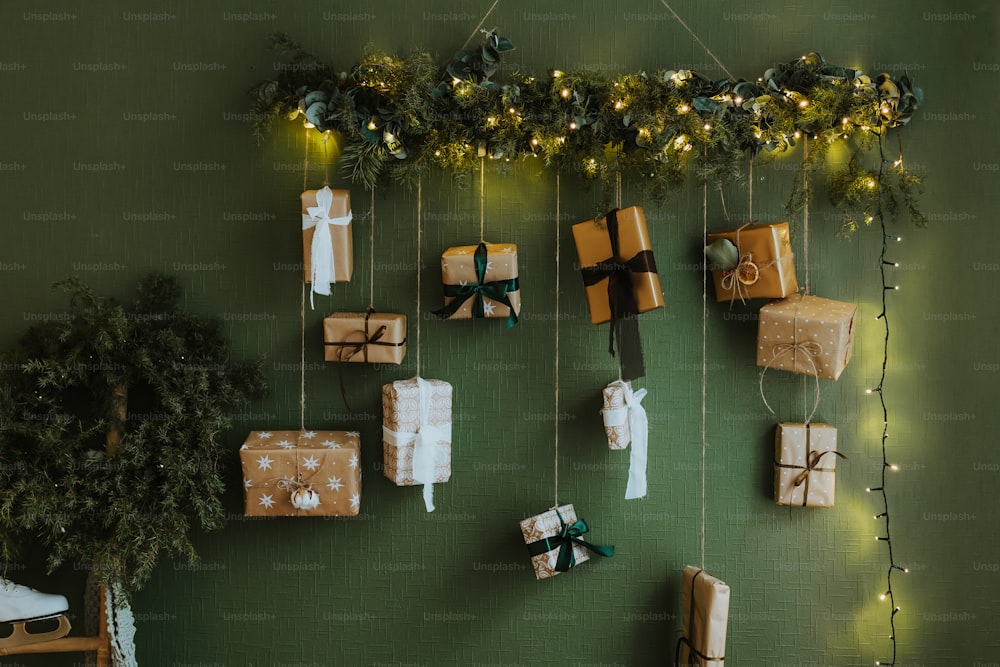 a green wall with presents hanging from it
