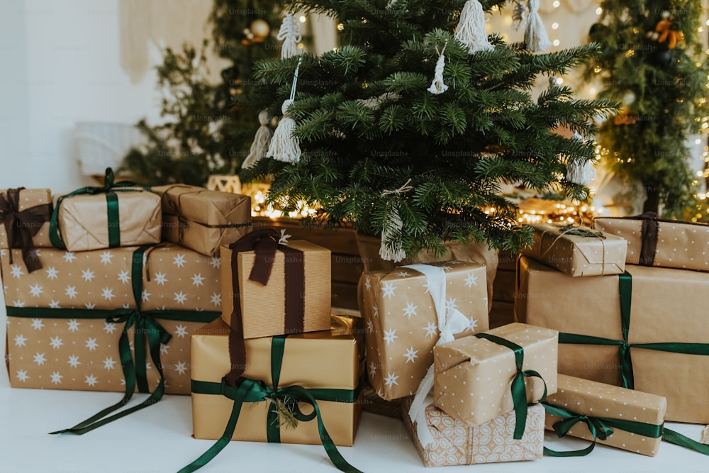 a group of wrapped presents under a christmas tree