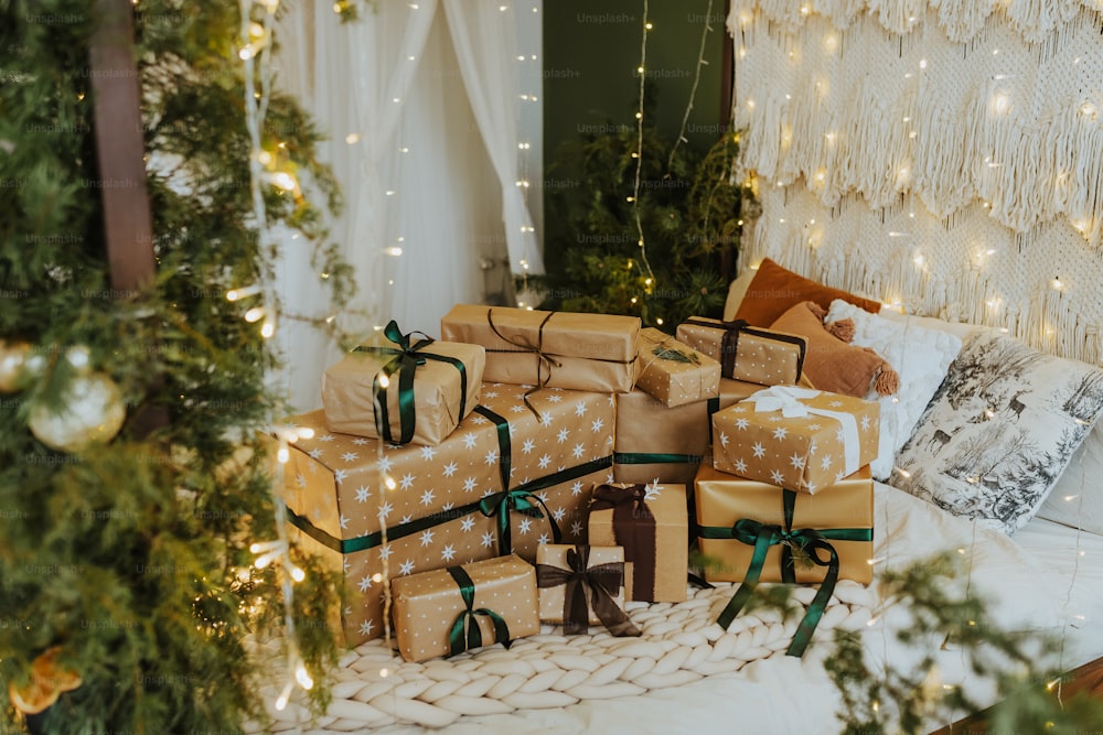 a pile of wrapped presents sitting on top of a bed