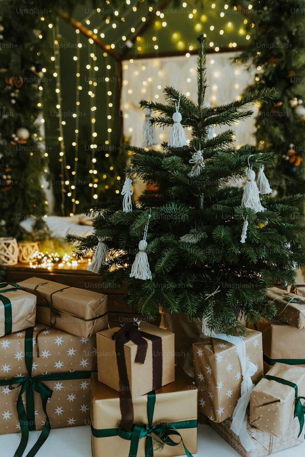 presents under a christmas tree with lights in the background