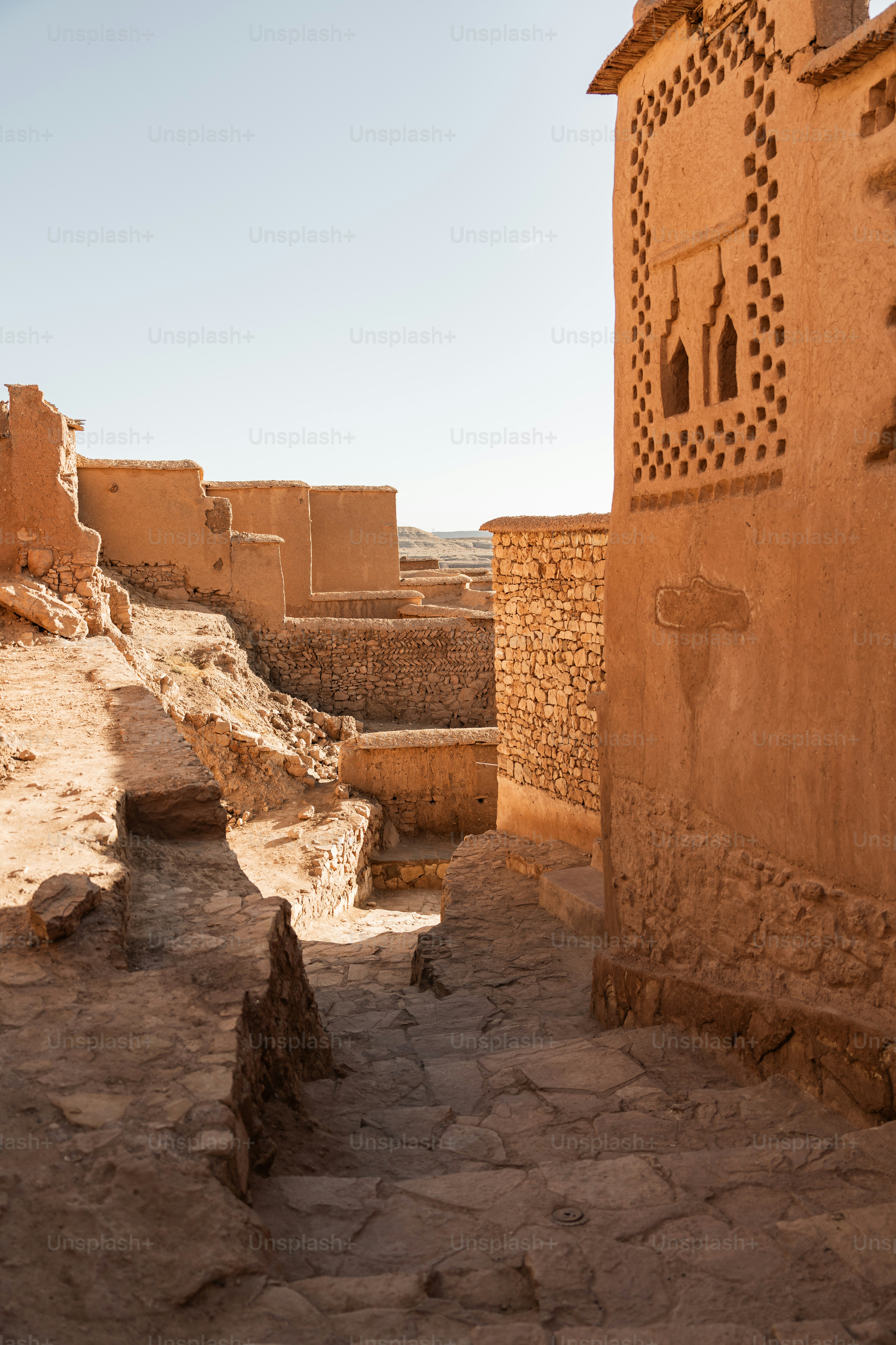 a stone building in the desert with a sky background