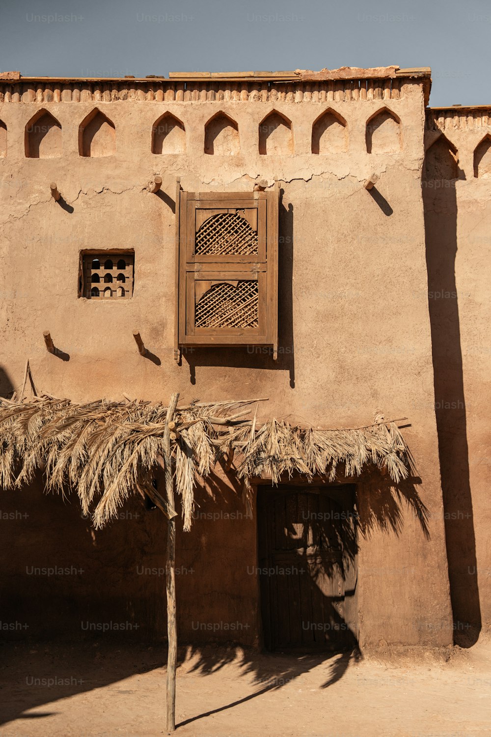 a building with a thatched roof and a door