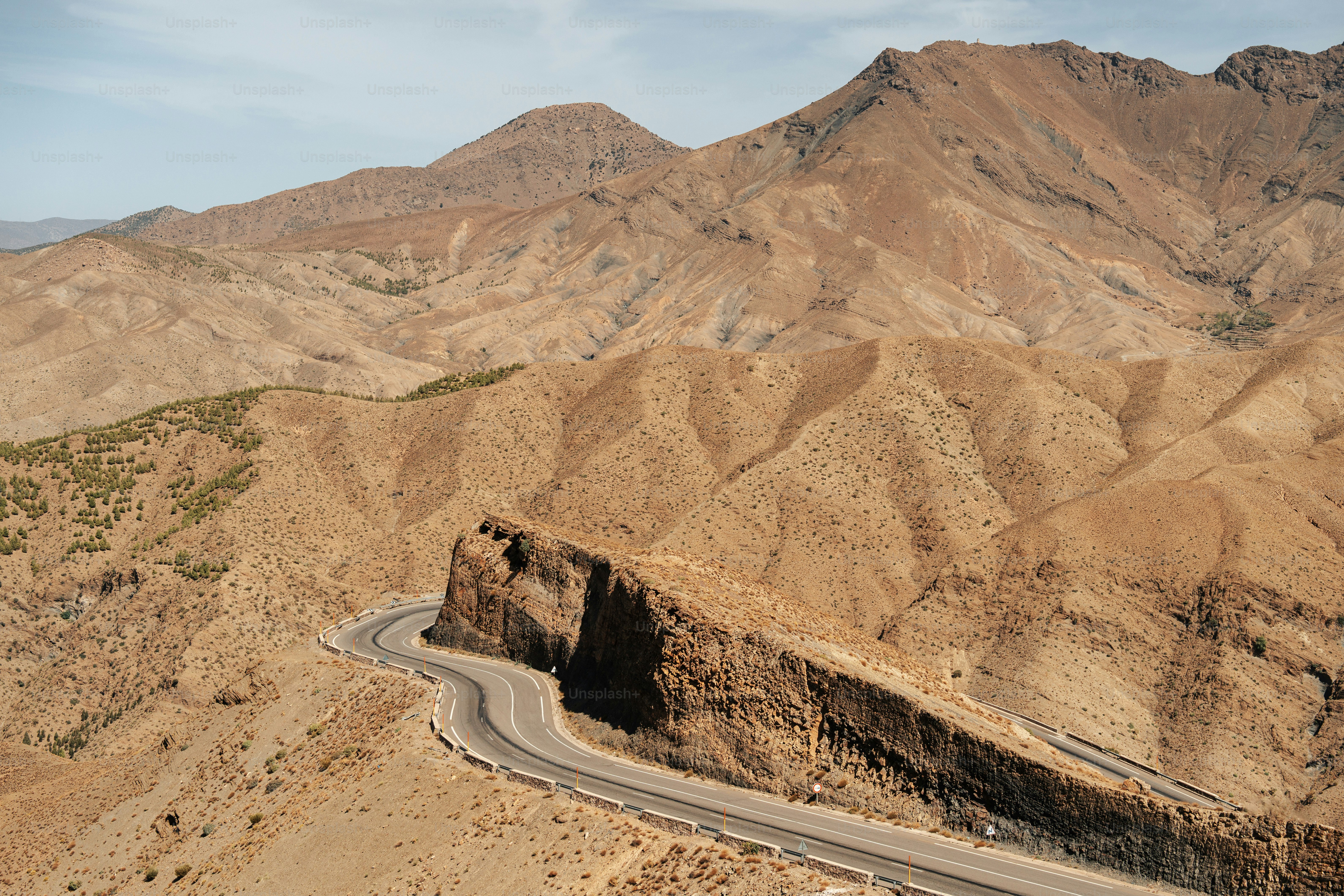 a winding road in the middle of a mountain range