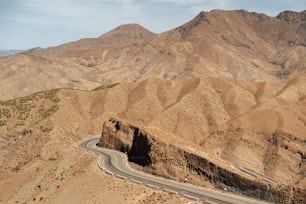 a winding road in the middle of a mountain range