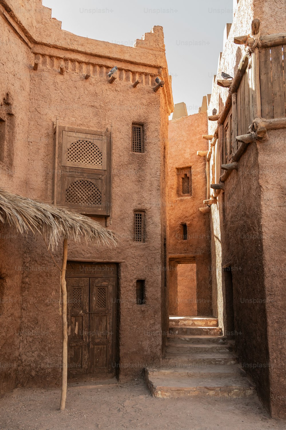 a building with a thatched roof and stairs