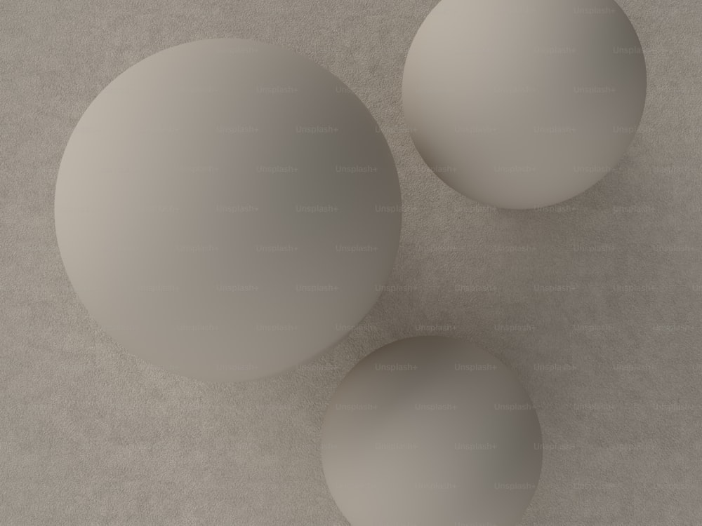 three white balls sitting on top of a table