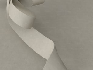 a sculpture of a curved white piece of paper