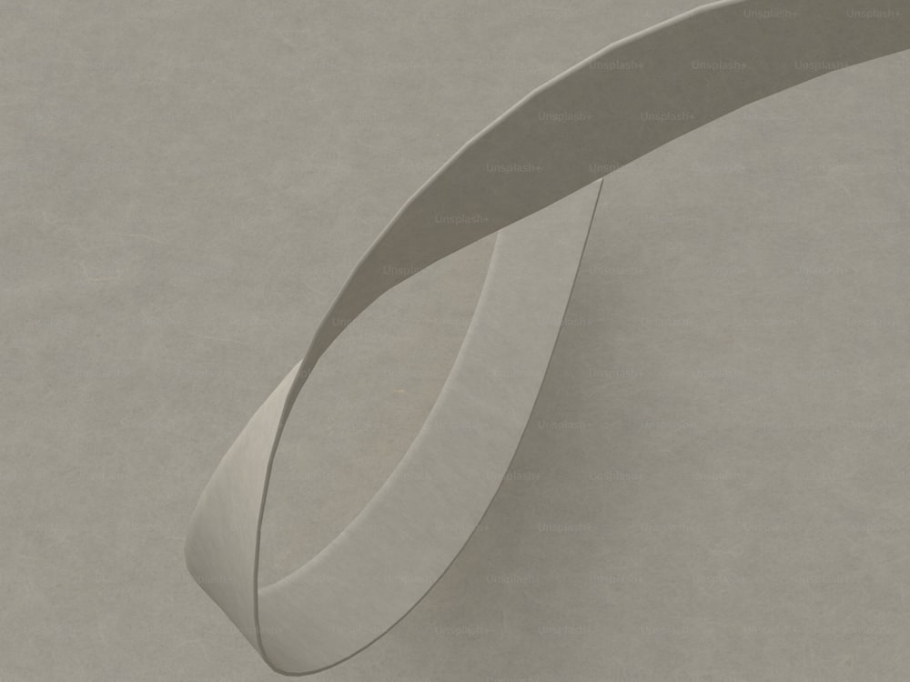 a curved metal object sitting on top of a table