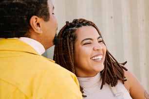 a man and a woman smiling at each other